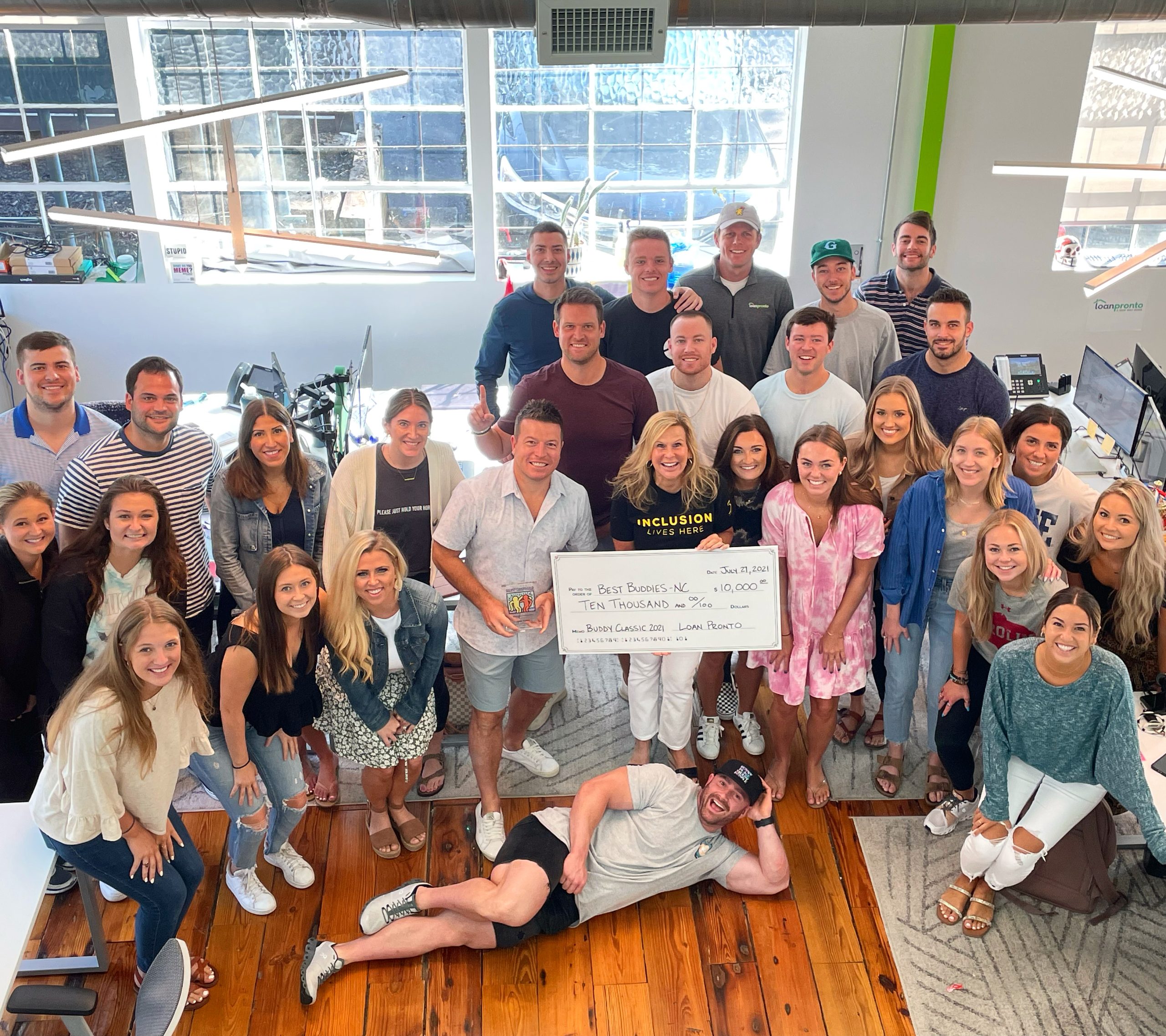 Tammy Medlock, State Director at Best Buddies North Carolina, receiving the $10,000 check raised by Loan Pronto through the 2nd Annual Buddy Classic.