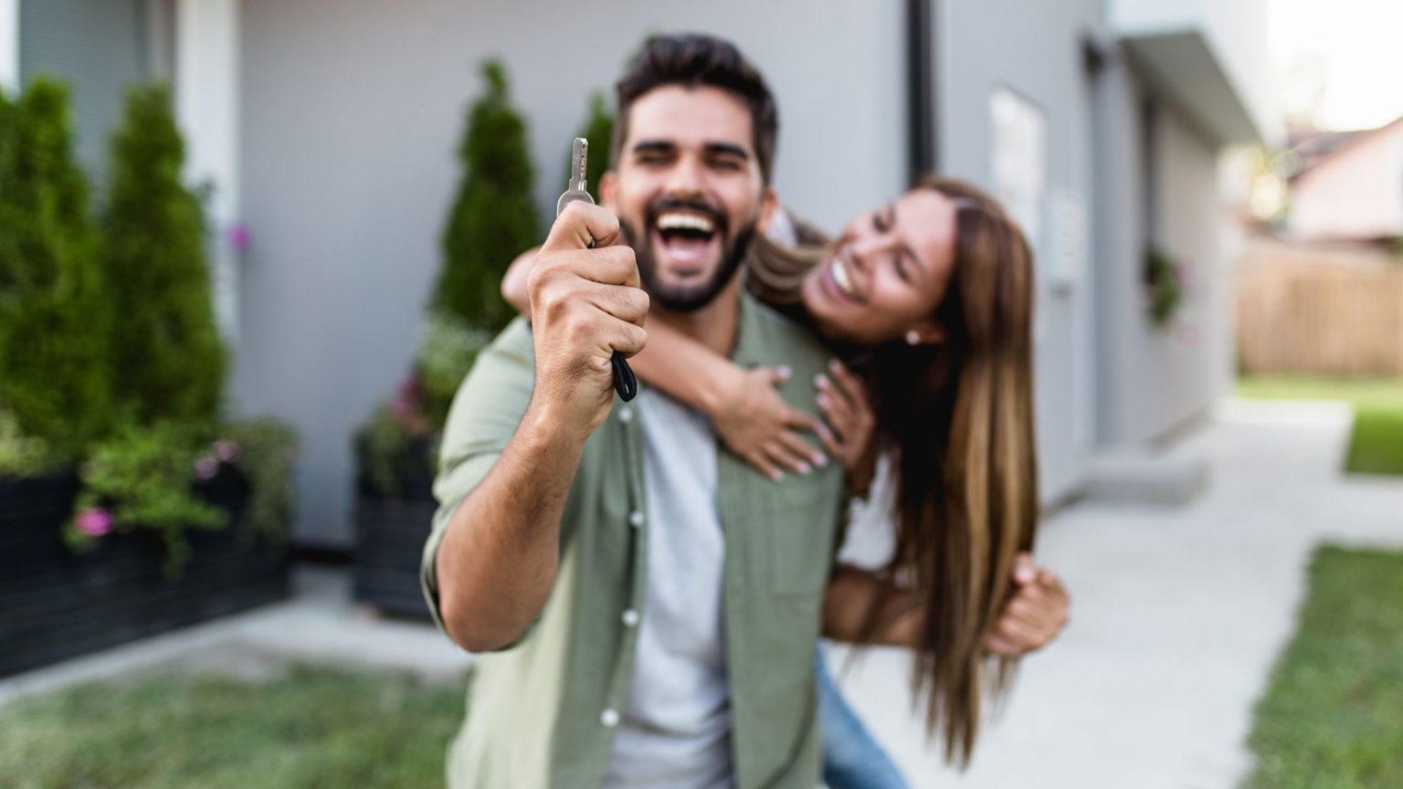 Young couple, first-time homebuyers, smiling and exciting about purchasing a home.