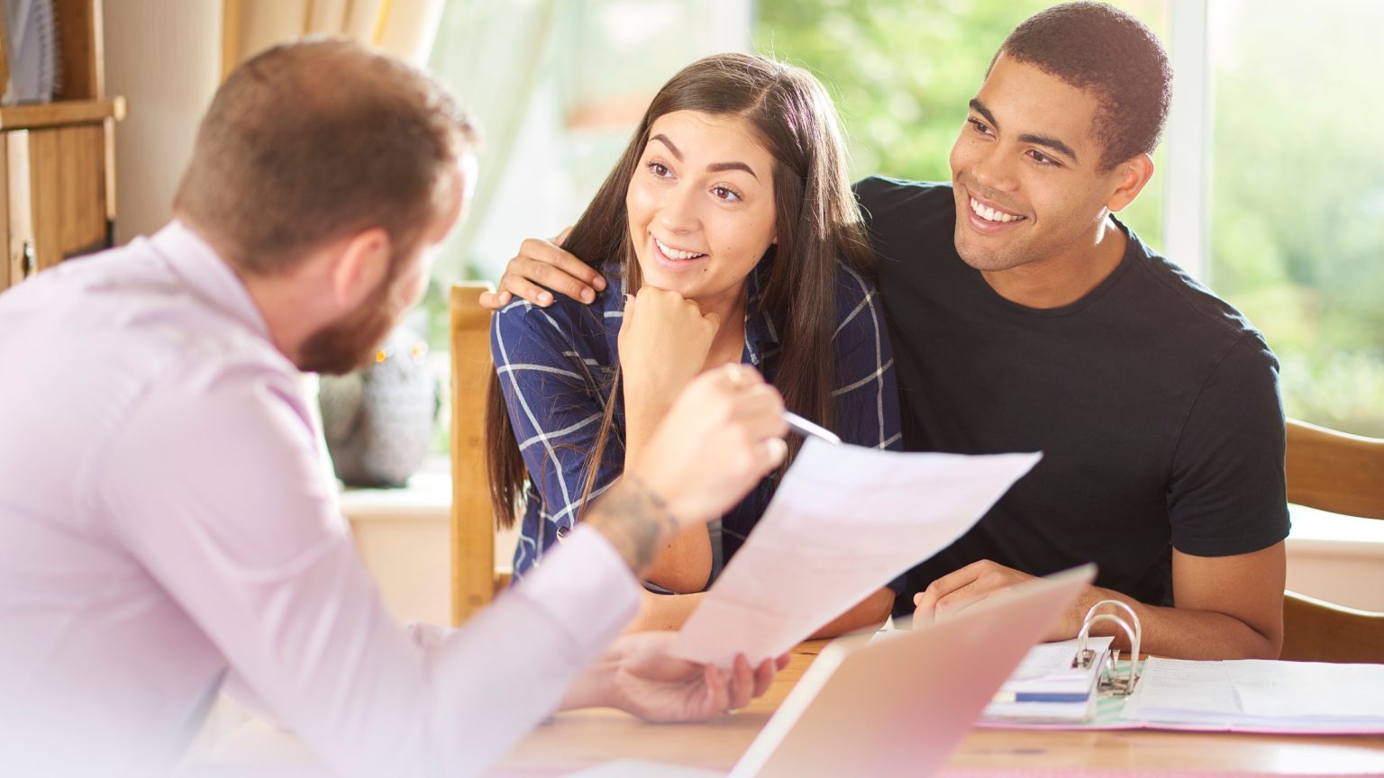 Homebuyers discussing with real estate agent after getting pre-approved for a mortgage.