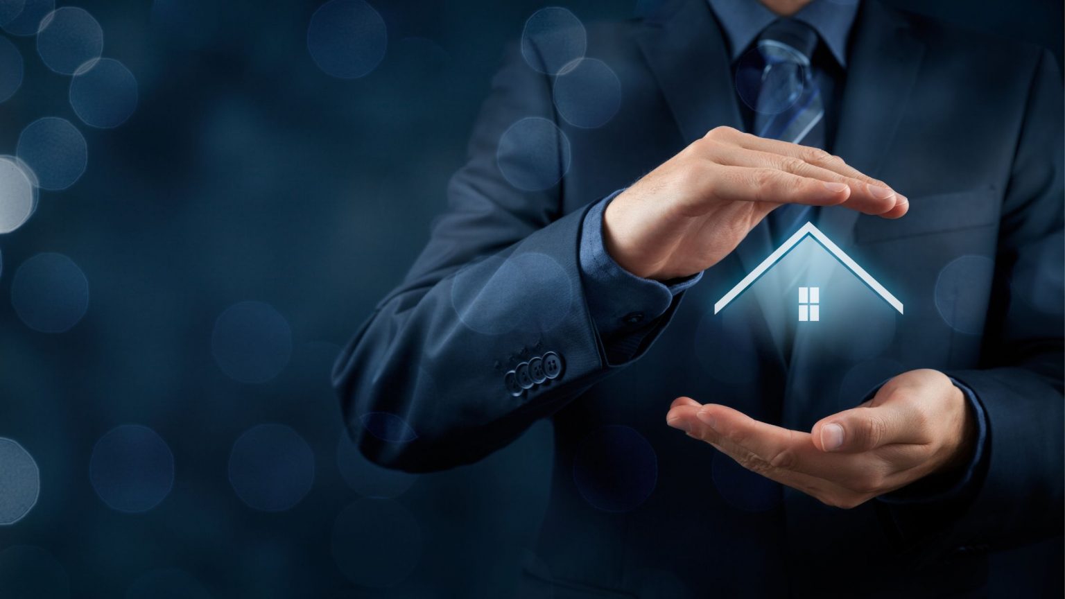 Man holding house between hands to indicate property investor.