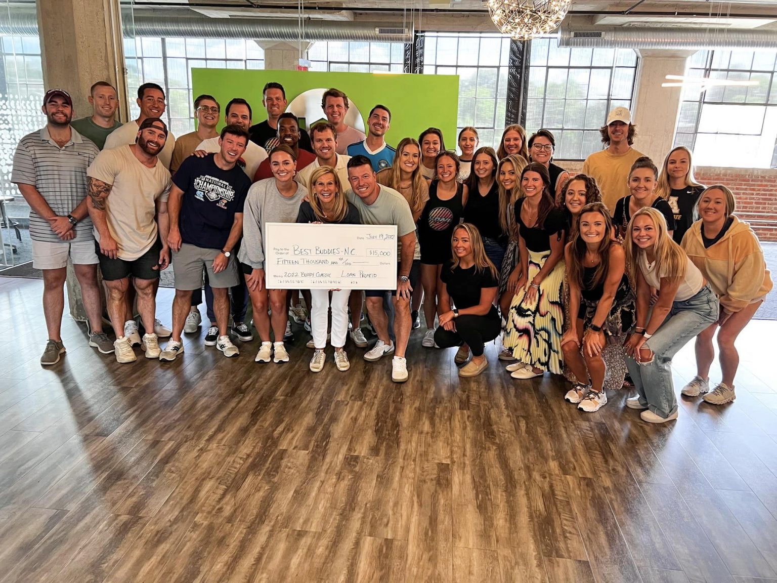 Loan Pronto group picture with Tammy Medlock, Best Buddies NC Director, after raising $15,000 for the organization at our 3rd Annual Buddy Classic golf tournament.