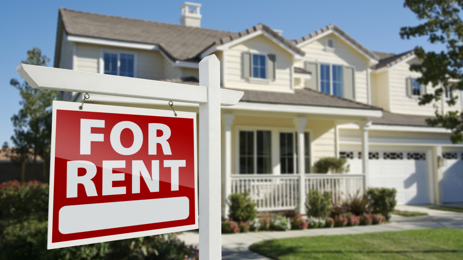 House with FOR RENT sign in front yard.